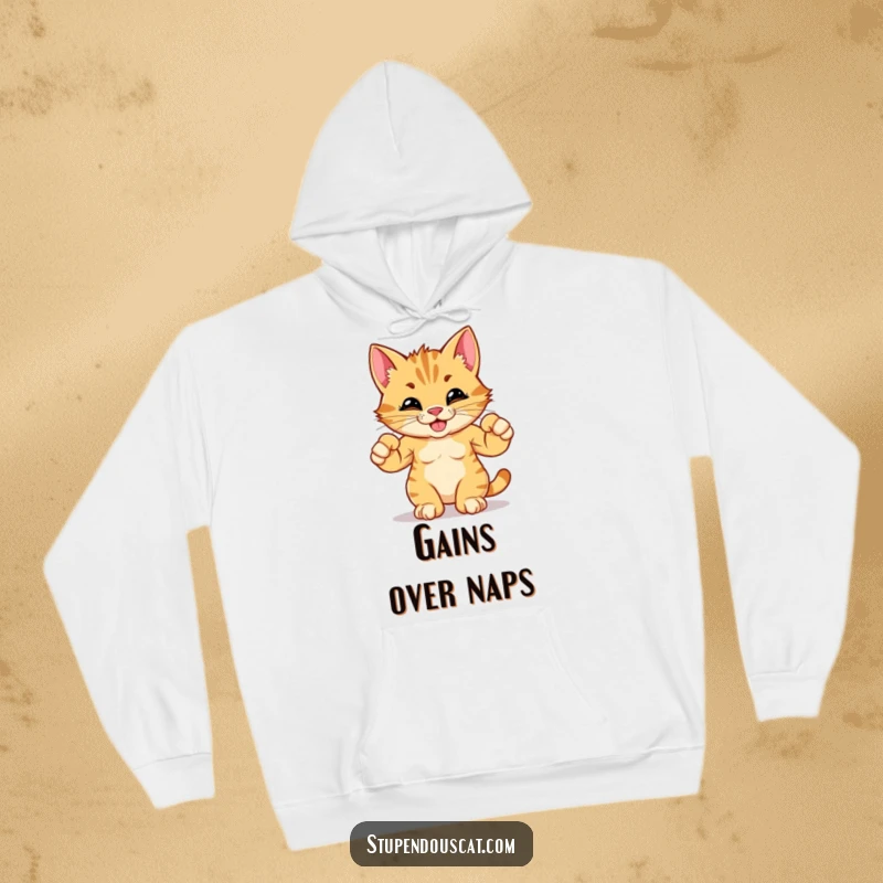 Funny hoodie showcasing a determined cat cub flexing its minuscule yet mighty muscles with a confident, humorous grin.