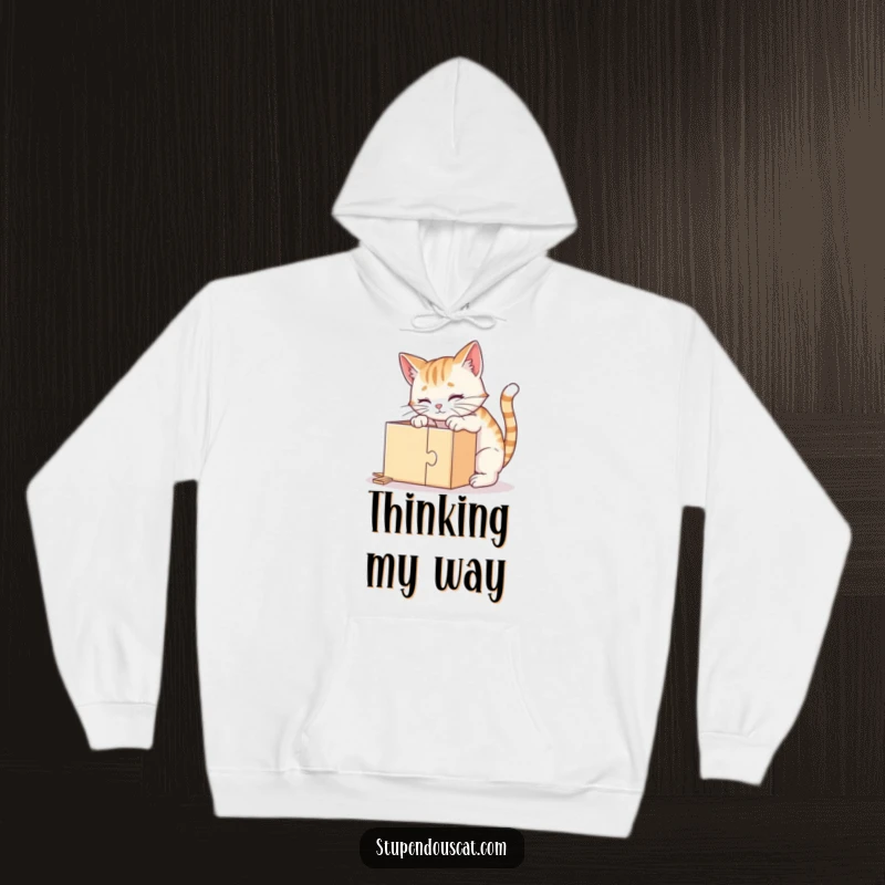 Funny hoodie showing a clever cat meticulously solving a puzzle box with great concentration and interest, perfect for cozy contemplation.