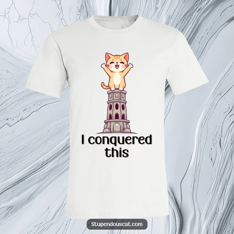 Funny Triumphant Cat T-Shirt: A brave cat standing victoriously atop an impossible structure, symbolizing ultimate success.